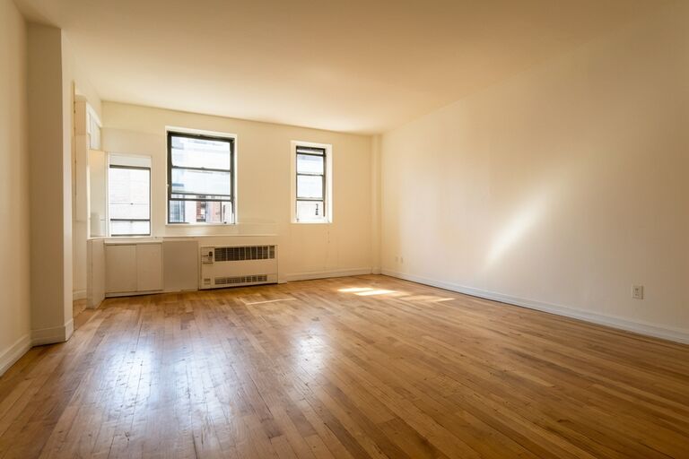 Clean empty Bronx apartment living room ready for new occupant after cleanout