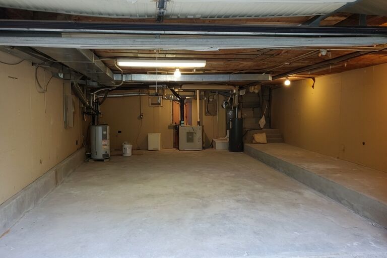 Clean empty residential basement after complete cleanout with open floor space