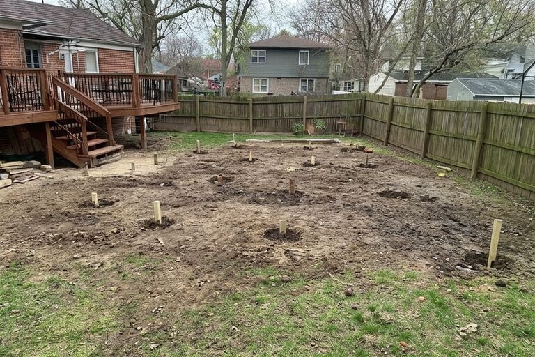 Clean cleared backyard area where a deck used to stand ready for rebuilding