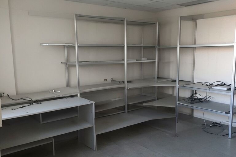 Clean empty desk area and shelves after all old electronics have been removed