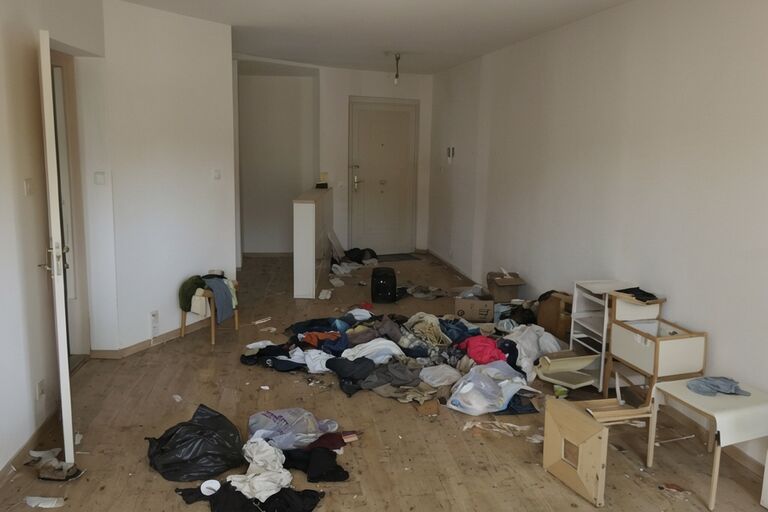 Vacant apartment with scattered abandoned belongings after tenant eviction