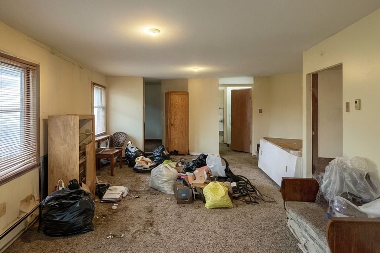 Rental apartment unit with leftover furniture and items left behind by tenant
